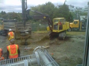Photo of construction crew using heavy equipment.