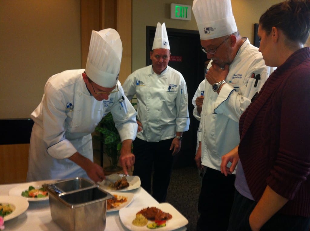 Photo of judges sampling one of the dishes.