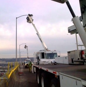 Photo of crew installing LED streetlights on the West Seattle Bridge.