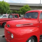 Photo of an old, red Ford pickup.