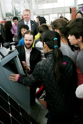 Photo of Jack Newman and students with the MobE kiosk.