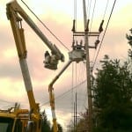 Photo of lineworkers installing an automated switch.