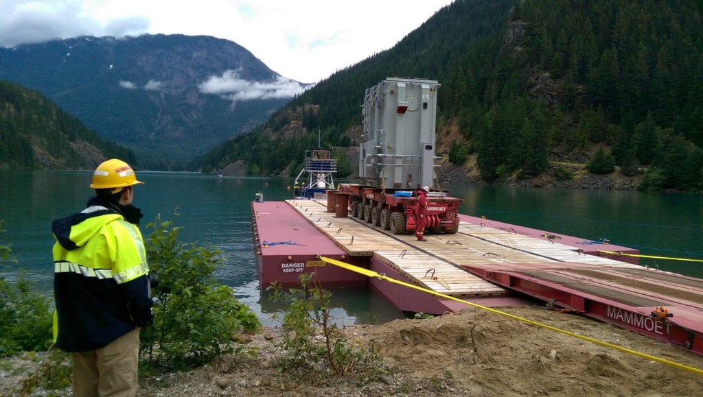 Photo of transformer being loaded onto a barge.