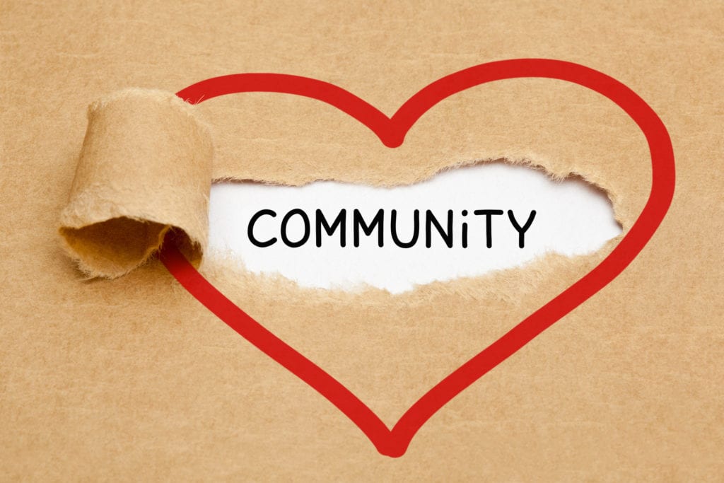 the word community with a heart drawn around it