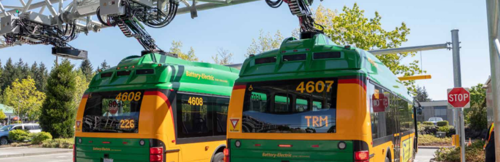 Green and yellow King County Metro electric buses
