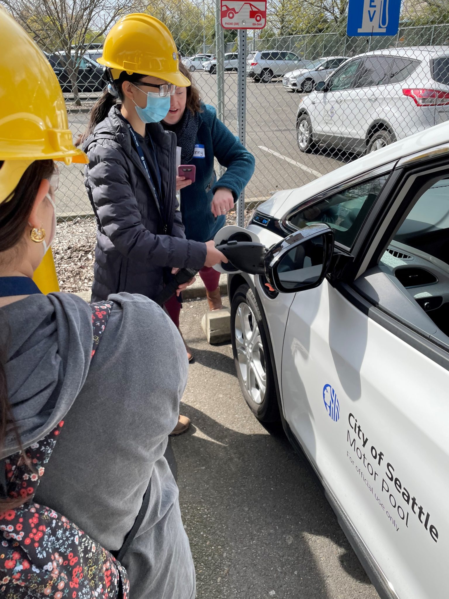 Jenny Levesque shows student how to plug in an electric vehicle