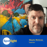 Weylin McGraw standing in front of colorful art