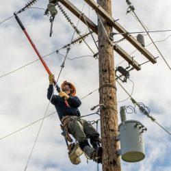 lineworker working on a pole