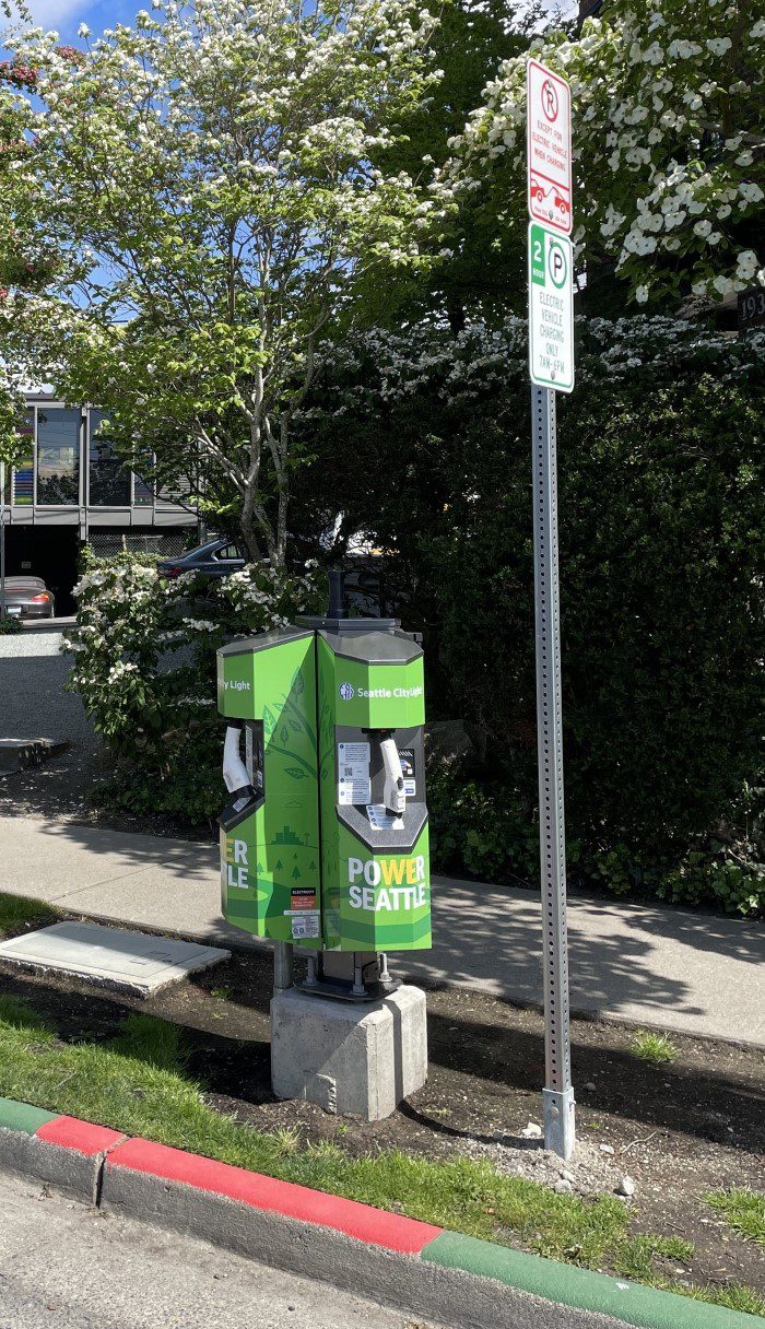 Pedestal style Level 2 EV charger installed along the street curbside in a Seattle neighborhood.