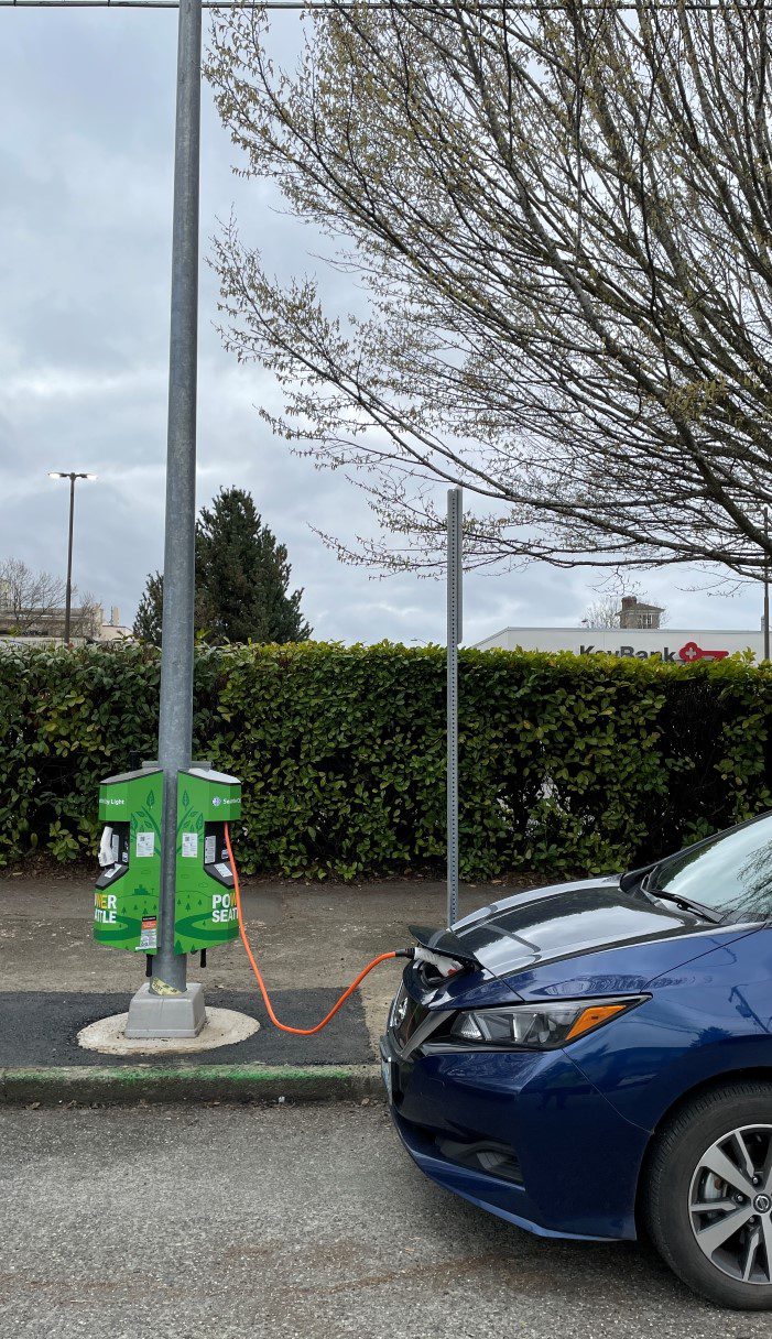 Steel pole mounted style Level 2 EV charger installed along the street curbside in a Seattle neighborhood.